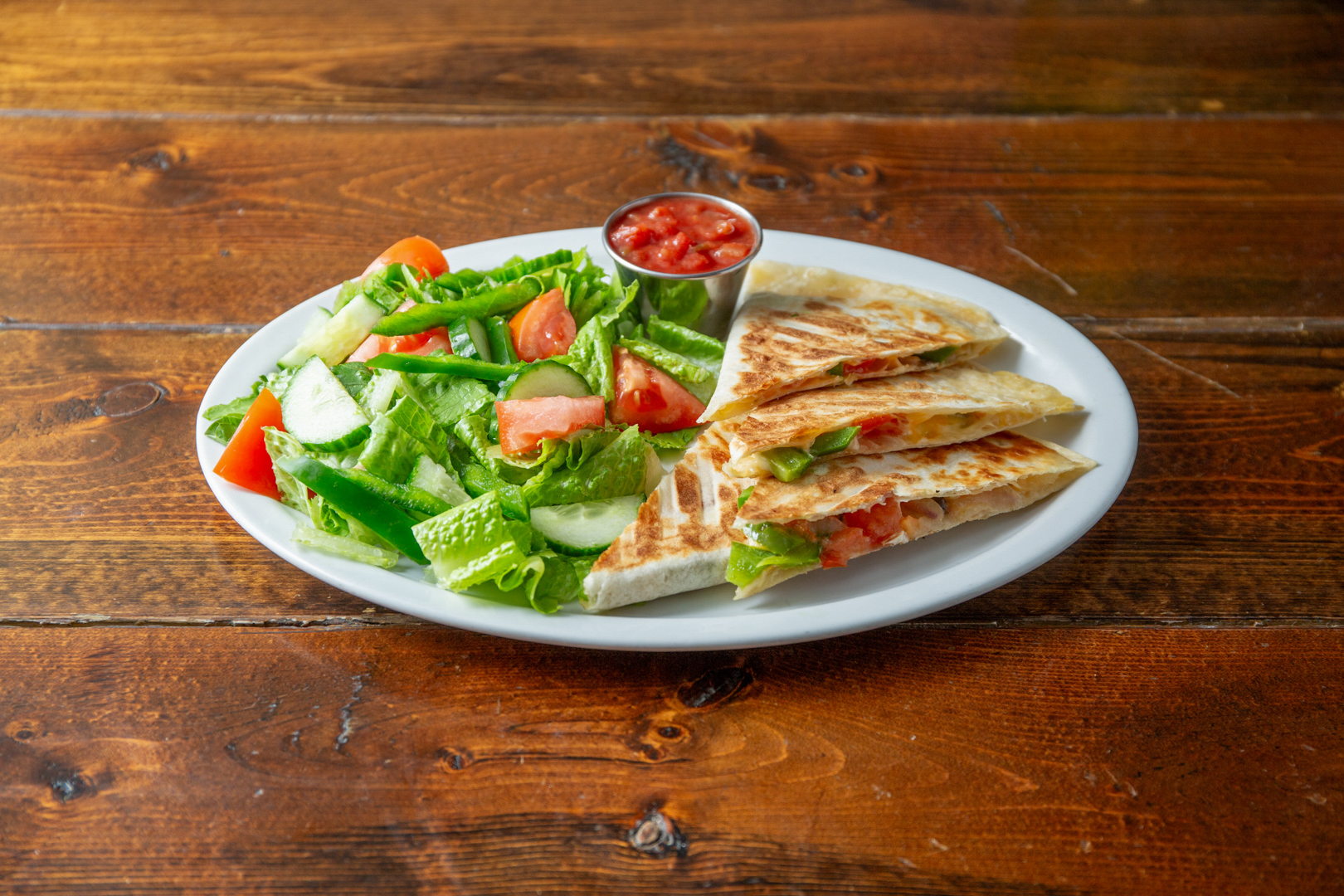 Veggie quesadilla plated with garden salad